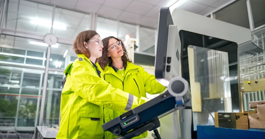 Two female engineers carry out CNC machining